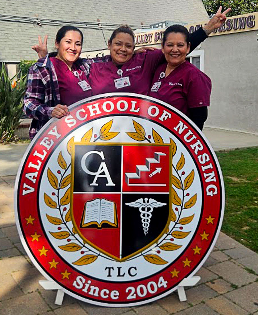 Students with sign, Valley School of Nursing 2